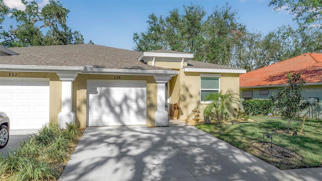 ranch-style home with a garage and a front lawn