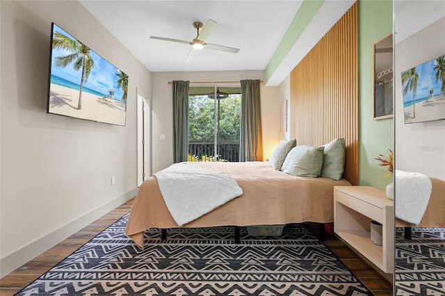 bedroom featuring access to exterior, ceiling fan, and dark wood-type flooring