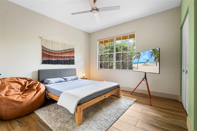 bedroom with hardwood / wood-style floors and ceiling fan