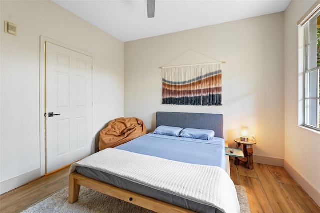 bedroom featuring hardwood / wood-style floors and ceiling fan