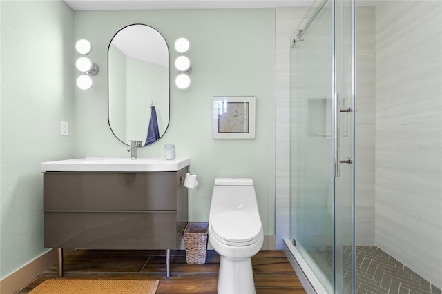 bathroom featuring vanity, toilet, and a shower with door