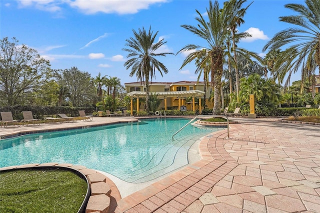 view of swimming pool with a patio and a hot tub