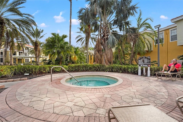 view of swimming pool with a community hot tub and a patio