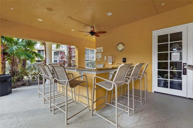 view of patio / terrace featuring ceiling fan and an outdoor bar