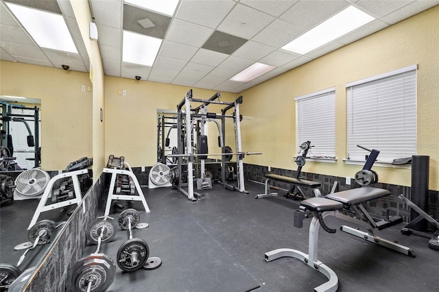 workout area featuring a paneled ceiling