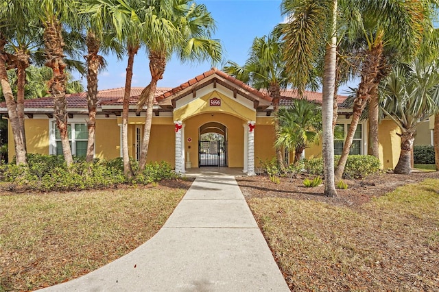 mediterranean / spanish-style house featuring a front yard