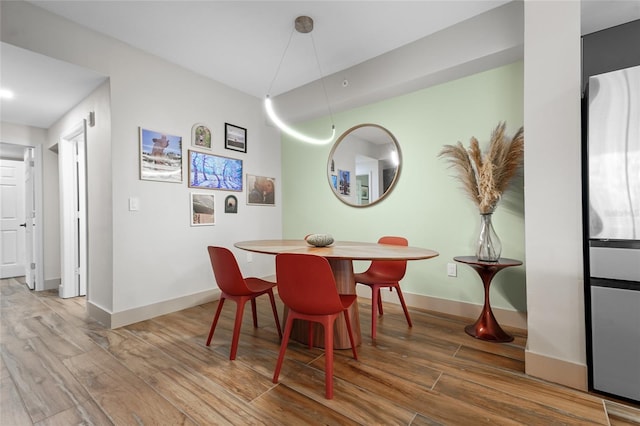 dining space featuring hardwood / wood-style flooring