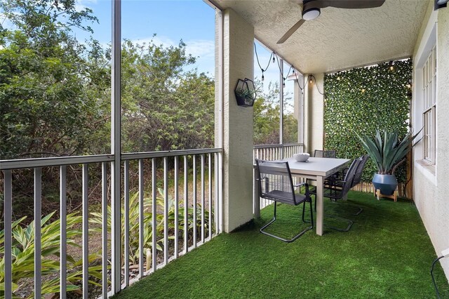 unfurnished sunroom featuring ceiling fan