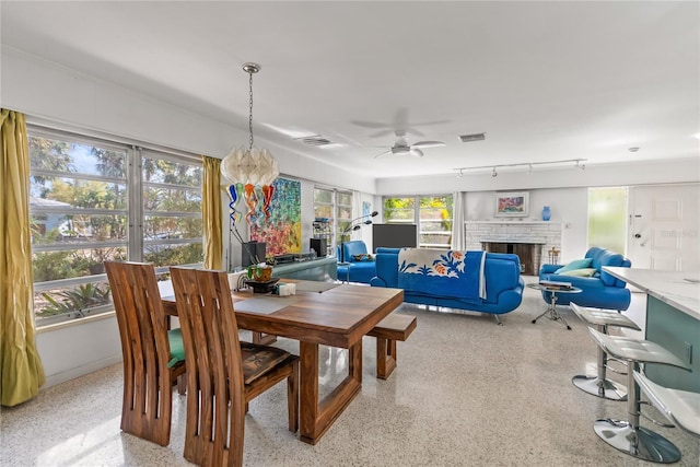 dining room with ceiling fan with notable chandelier