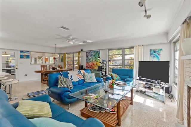 living room with ceiling fan and a fireplace