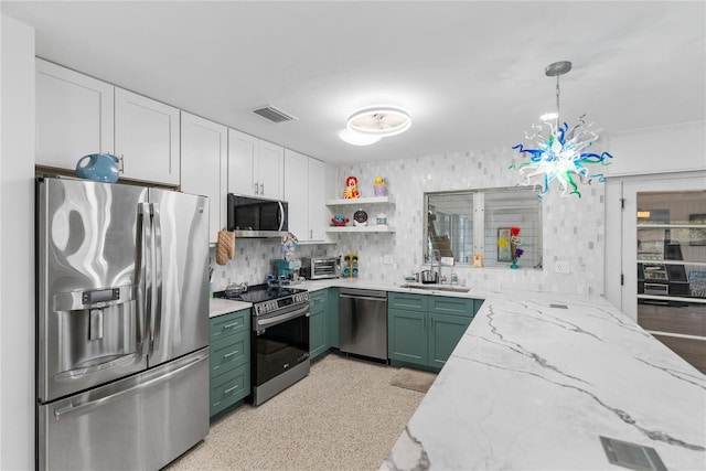 kitchen featuring appliances with stainless steel finishes, light stone counters, white cabinets, hanging light fixtures, and green cabinets