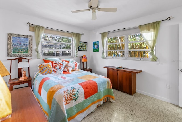 bedroom with multiple windows and ceiling fan