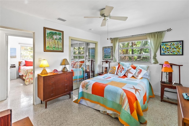 bedroom featuring a closet, multiple windows, and ceiling fan