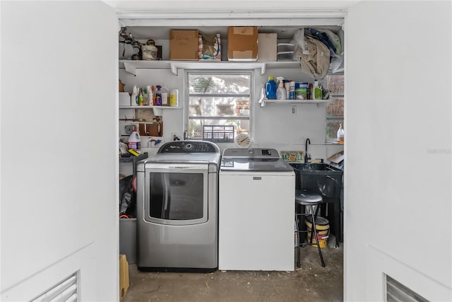 laundry area with independent washer and dryer