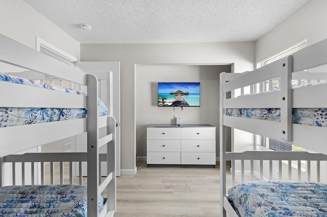 bedroom featuring a textured ceiling and light wood-type flooring