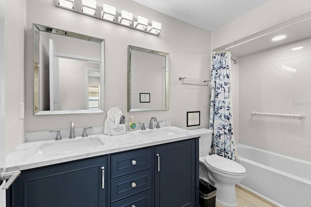 full bathroom with vanity, shower / bathtub combination with curtain, and toilet