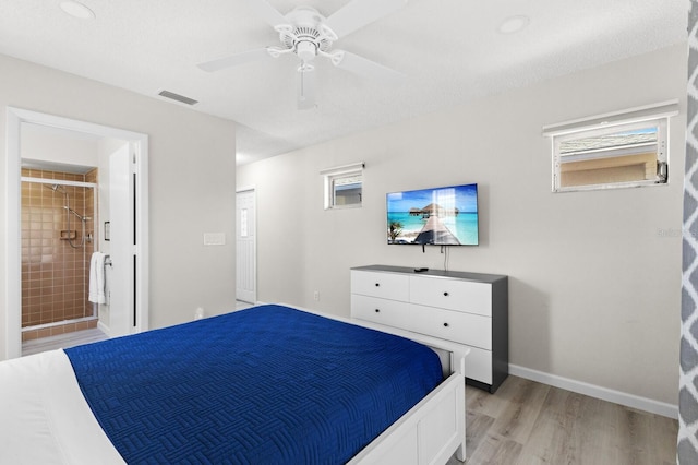 bedroom with ensuite bathroom, ceiling fan, and light wood-type flooring