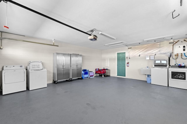 garage featuring sink, washer and dryer, and a garage door opener