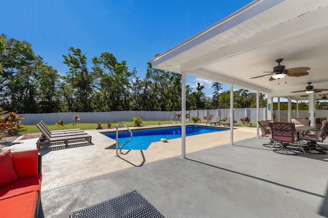 view of pool with a patio and ceiling fan