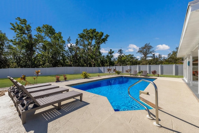 view of pool featuring a lawn and a patio area