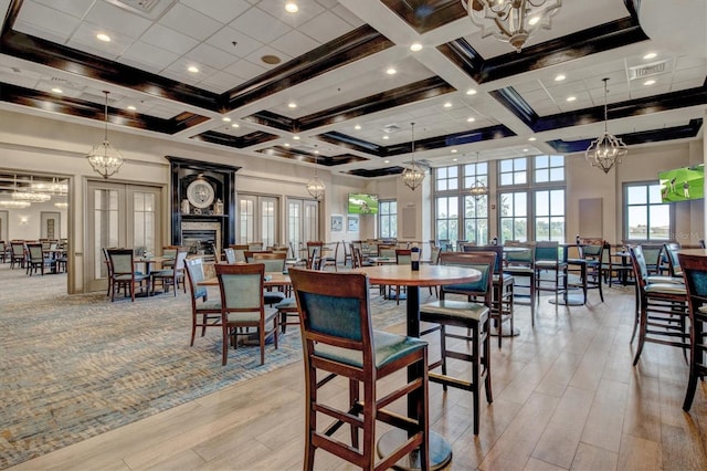 dining space featuring a high ceiling, french doors, and beamed ceiling