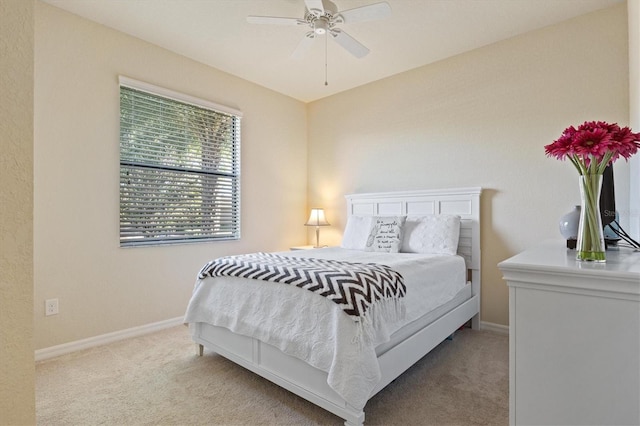 bedroom featuring ceiling fan and light carpet