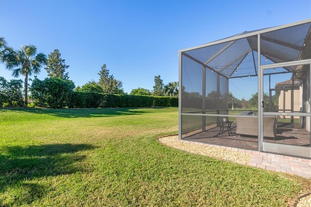 view of yard featuring a patio and glass enclosure