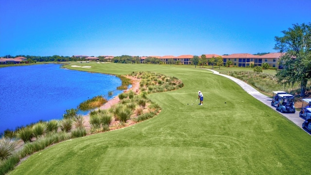 surrounding community featuring a yard and a water view