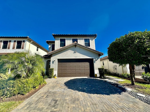 mediterranean / spanish house featuring a garage