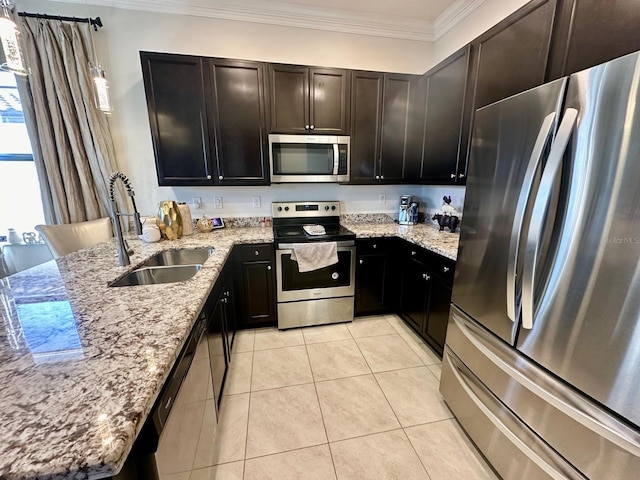 kitchen with light stone countertops, sink, appliances with stainless steel finishes, light tile patterned floors, and ornamental molding