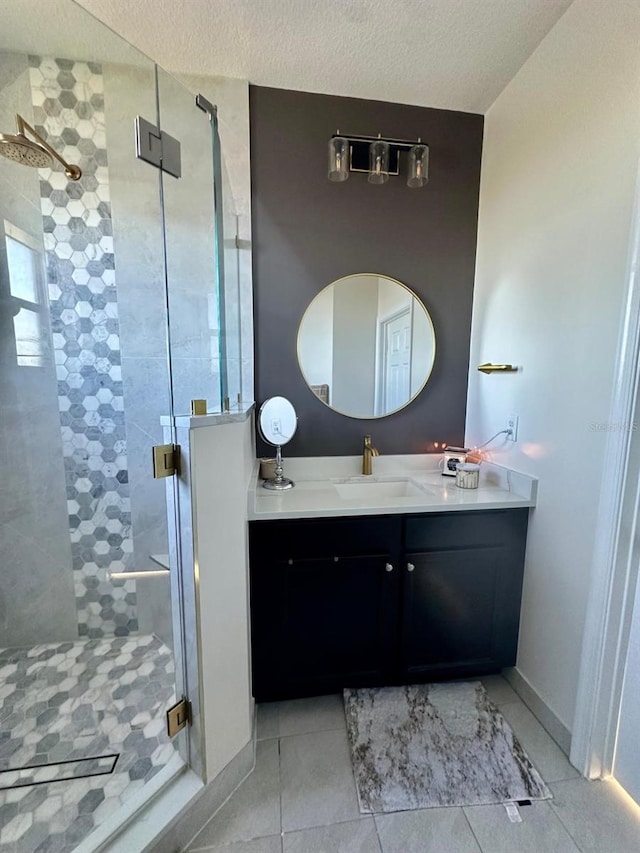 bathroom featuring vanity, a textured ceiling, tile patterned floors, and an enclosed shower