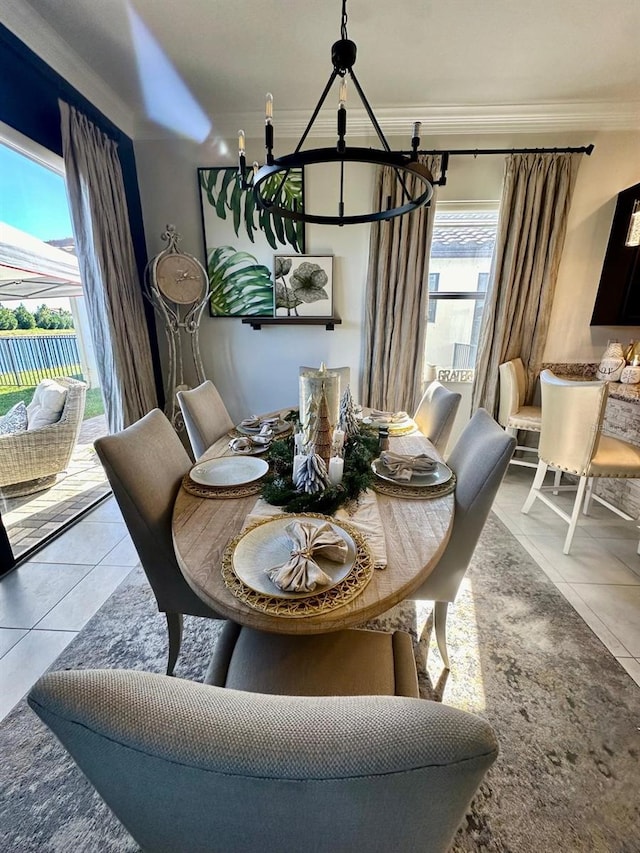 tiled dining area featuring ornamental molding and a notable chandelier