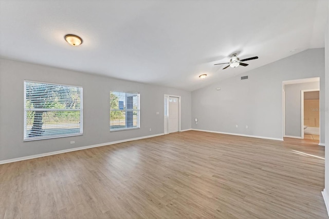 empty room with ceiling fan, light hardwood / wood-style flooring, and lofted ceiling