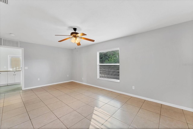 unfurnished room with ceiling fan and light tile patterned floors