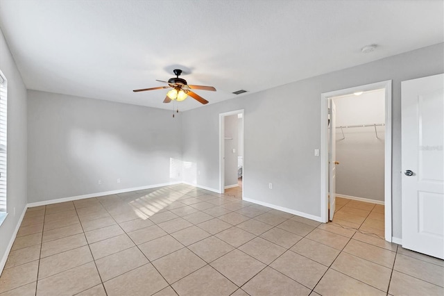 tiled empty room with ceiling fan