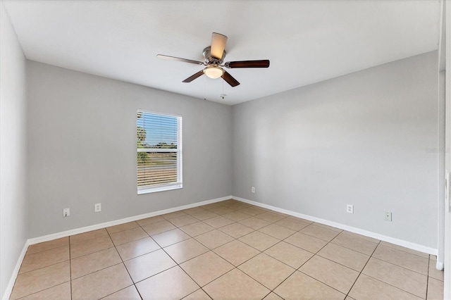 spare room featuring ceiling fan and light tile patterned flooring