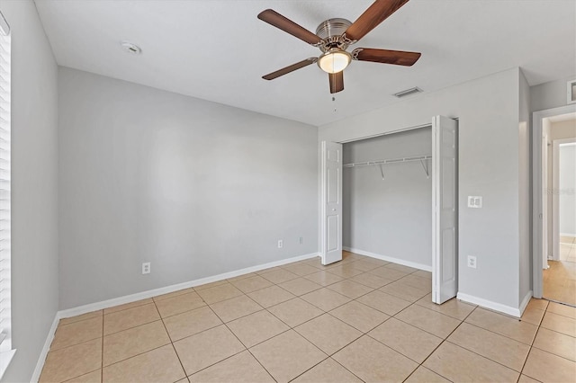 unfurnished bedroom featuring ceiling fan, light tile patterned floors, and a closet