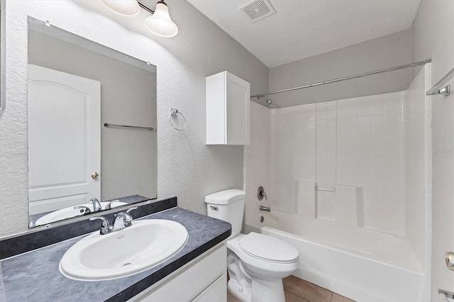 full bathroom featuring tile patterned floors, vanity, toilet, and shower / bath combination