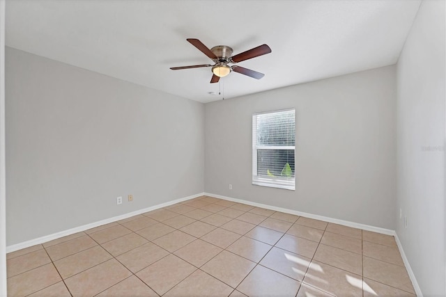 empty room featuring ceiling fan and light tile patterned floors