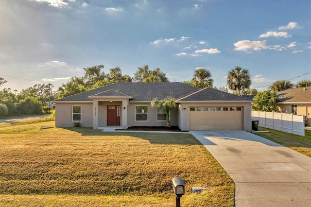 single story home with a front yard and a garage