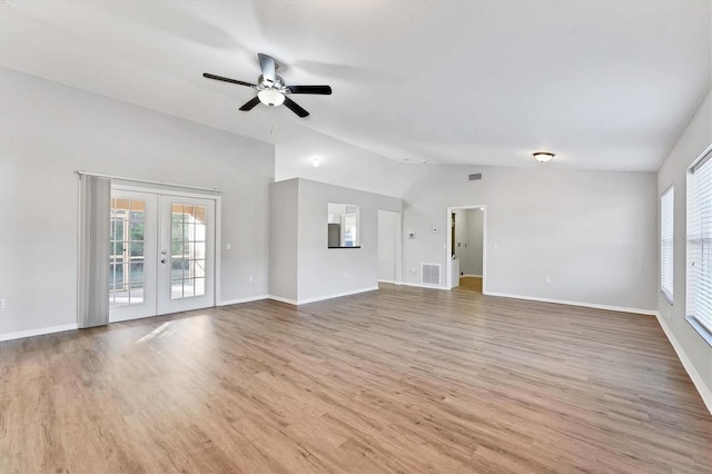 unfurnished living room featuring french doors, light wood-type flooring, ceiling fan, and lofted ceiling