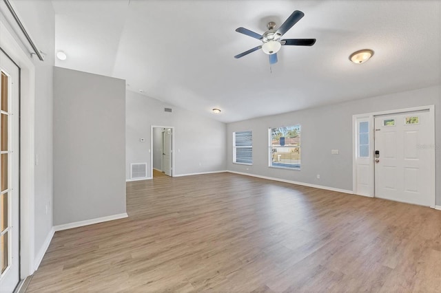 interior space featuring light wood-type flooring, vaulted ceiling, and ceiling fan