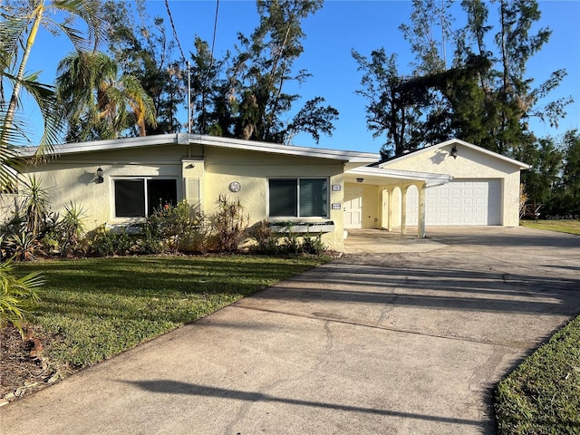 703 32nd Street Ct E, Bradenton, FL 34208 - view of front facade featuring stucco siding, driveway, a front yard, and an attached garage