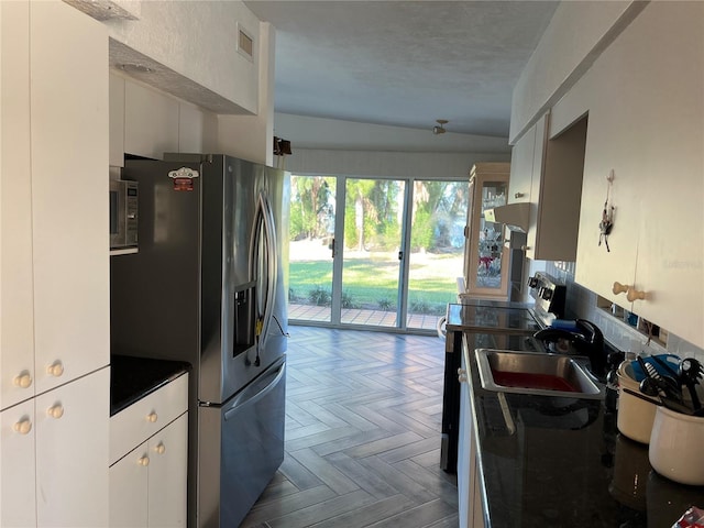 kitchen featuring white cabinetry, sink, dark parquet floors, and stainless steel appliances