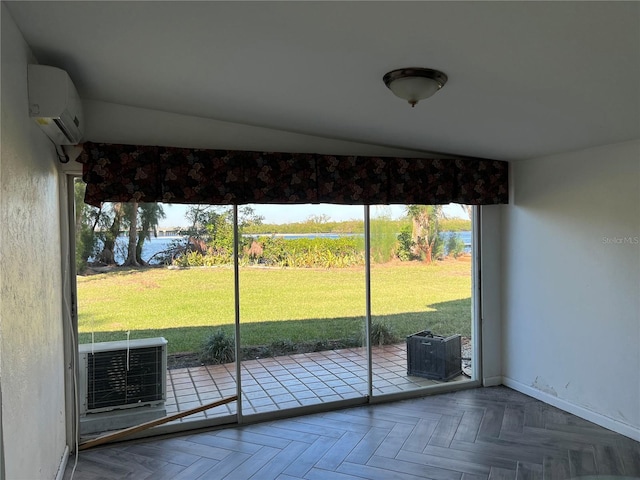 doorway with a water view, parquet floors, and a wall mounted air conditioner