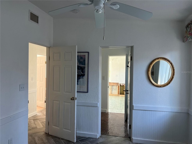 interior space with ceiling fan