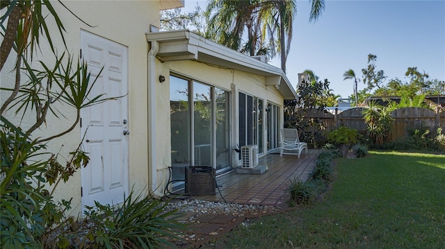 view of side of home with a patio area and a yard