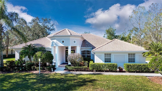 mediterranean / spanish-style house featuring a front lawn