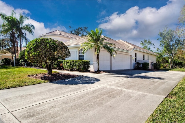 view of front of house with a garage and a front lawn