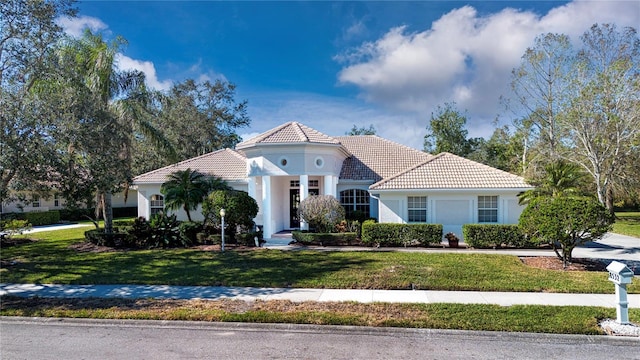 mediterranean / spanish home with a front yard